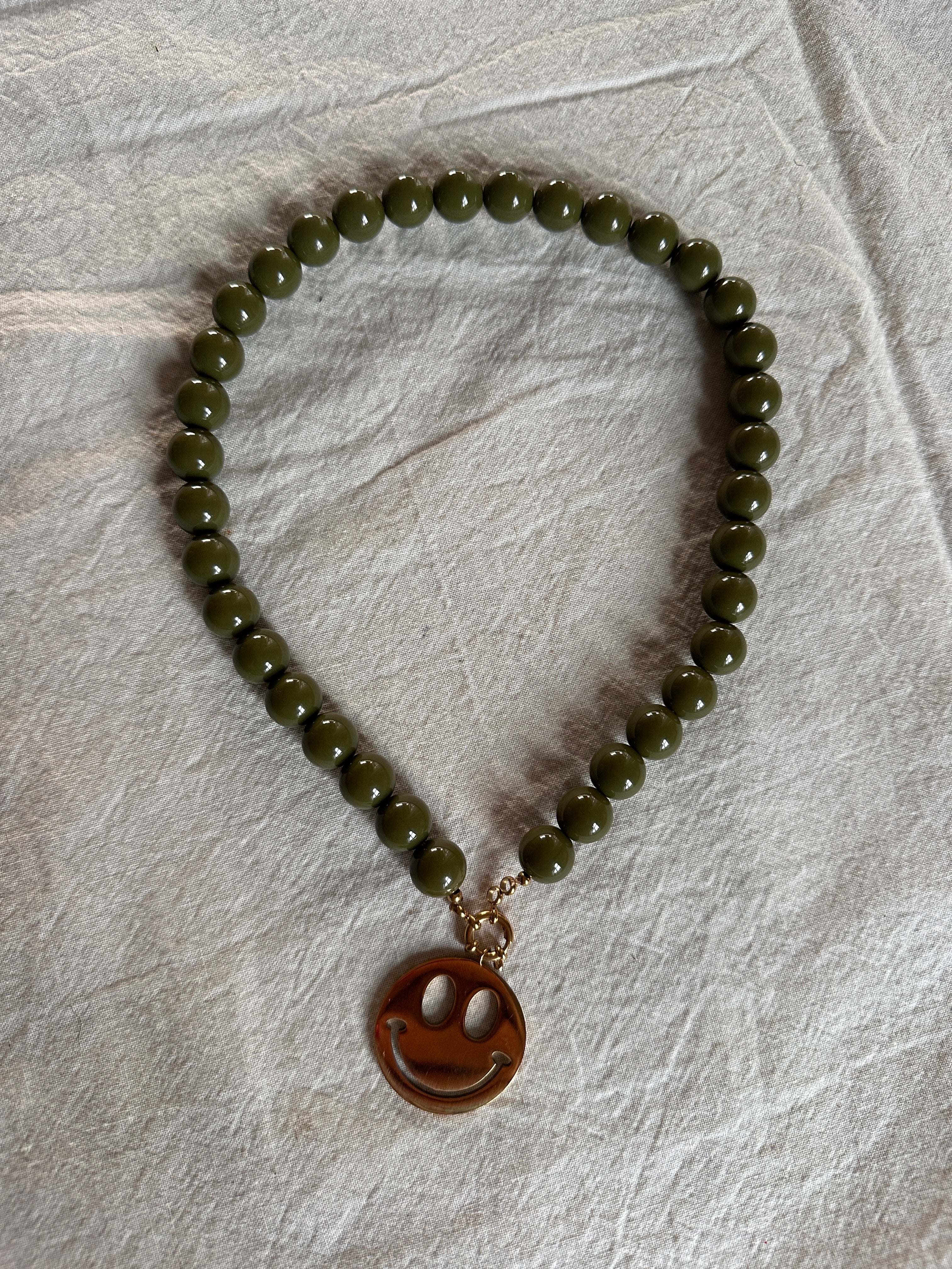 EVA MUSTHAVE KETTING MET SMILEY OLIJF